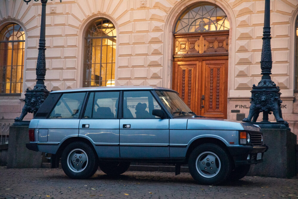 Vintage car parked near ornate building entrance