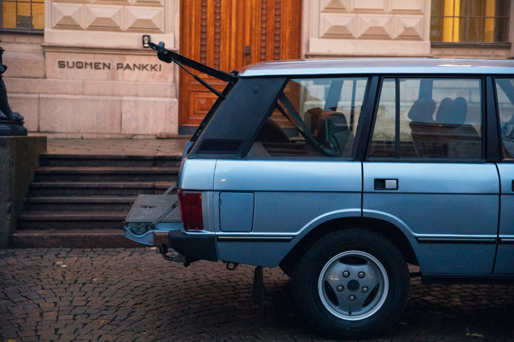 Vintage car parked outside Suomen Pankki building
