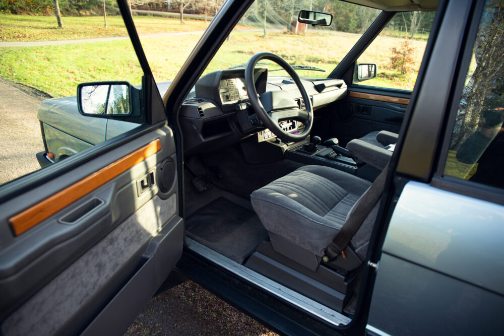 Vintage car interior with open driver side door
