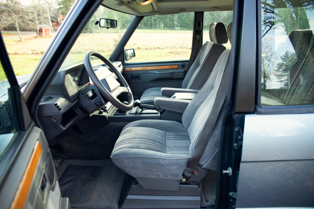 Vintage car interior with classic steering wheel and seats