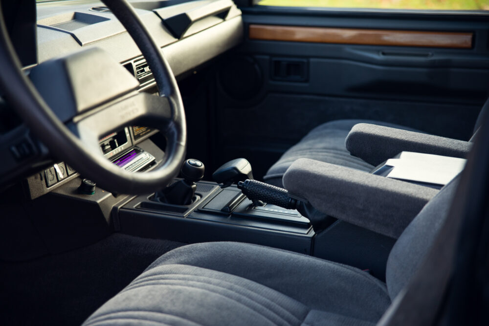 Vintage car interior with focus on gear shift.