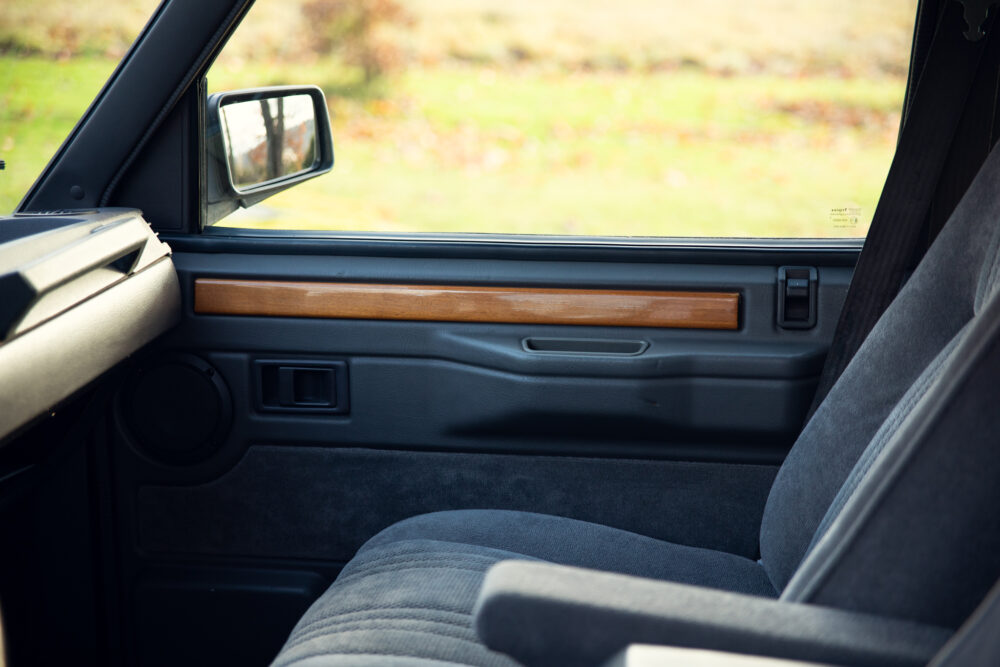 Classic car interior with wooden panel door