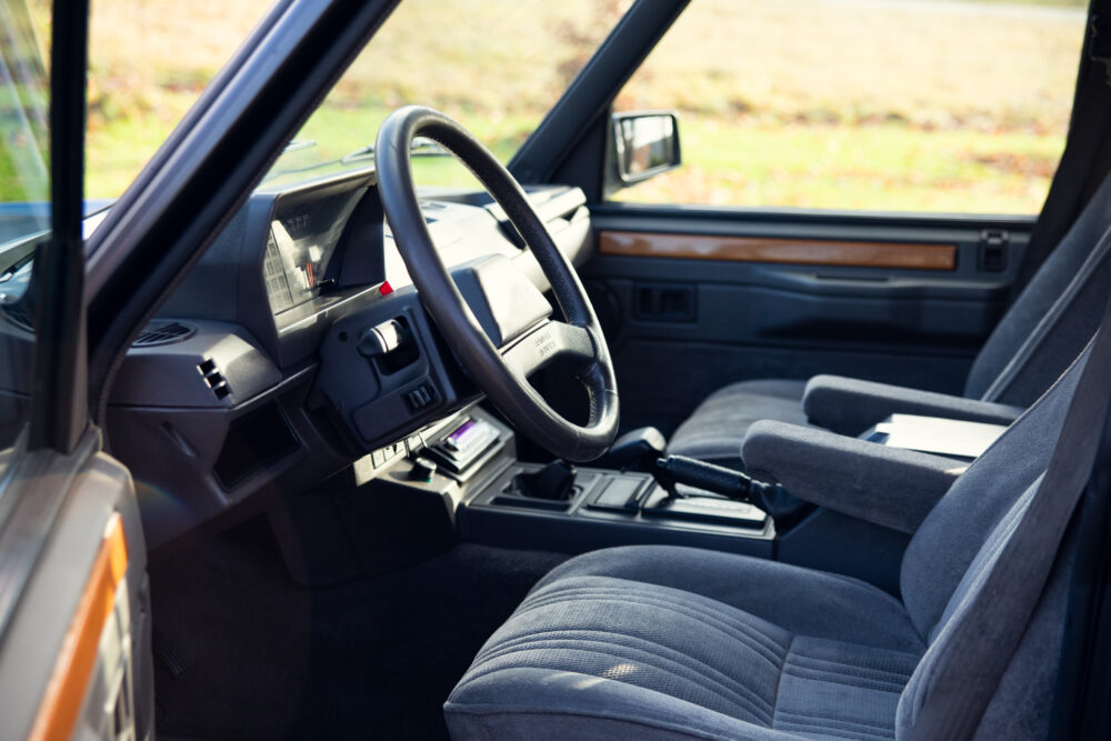 Vintage car interior with steering wheel and seats