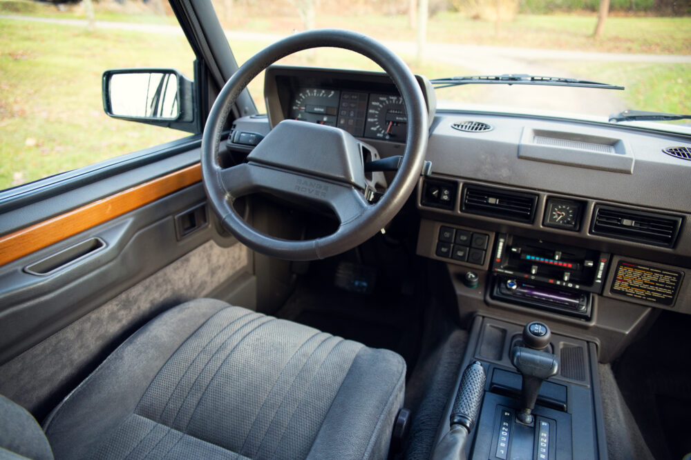 Vintage car interior, driver's view with steering wheel