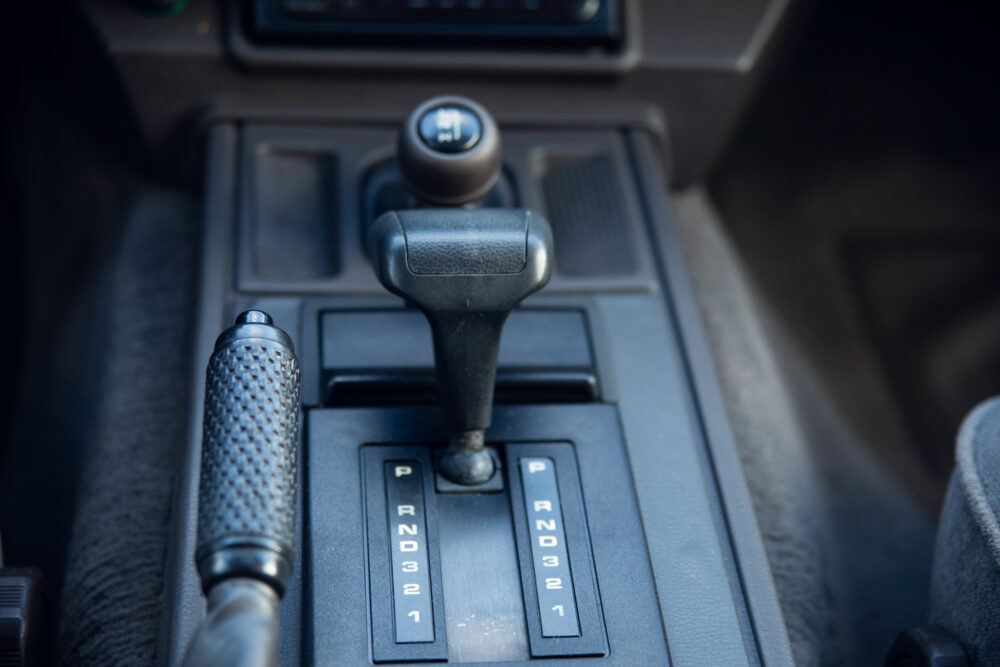 Close-up of car's gear shift and selector panel