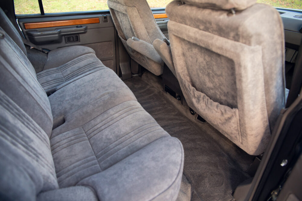 Interior view of a vintage car with gray seats