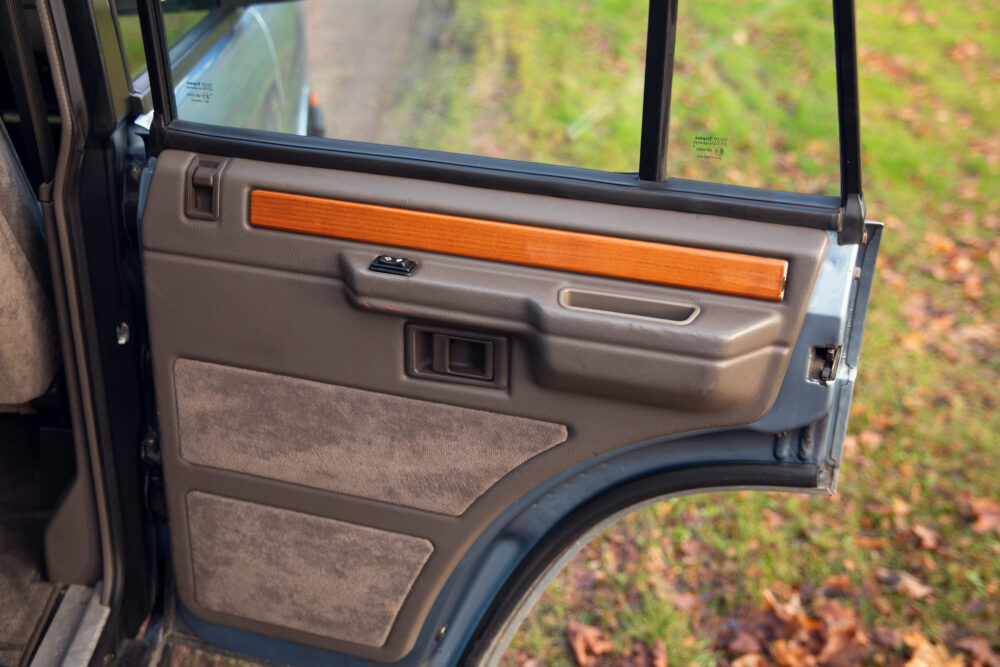 Open car door interior with wooden trim