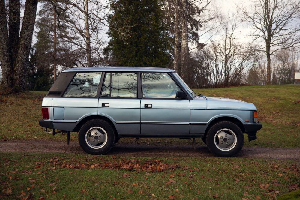 Vintage blue SUV parked outdoors near trees
