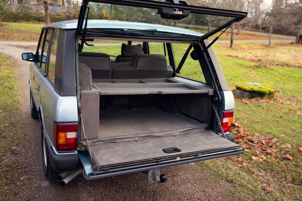 Open trunk of a silver SUV in a park