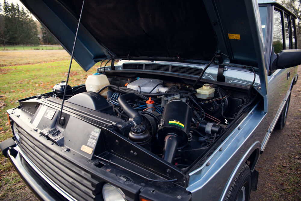 Open hood of vintage car showing engine