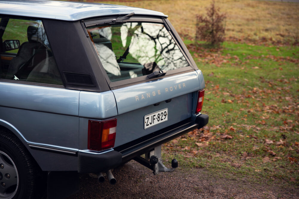Vintage blue Range Rover parked outdoors in autumn