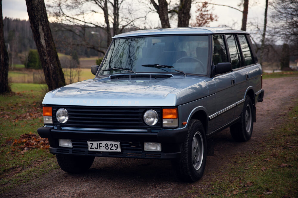 Vintage Range Rover parked on a country road