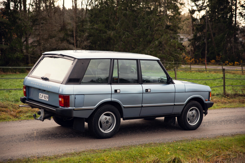 Vintage Range Rover parked in rural setting