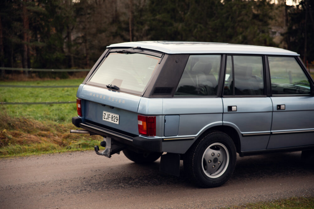 Vintage Range Rover parked in rural setting