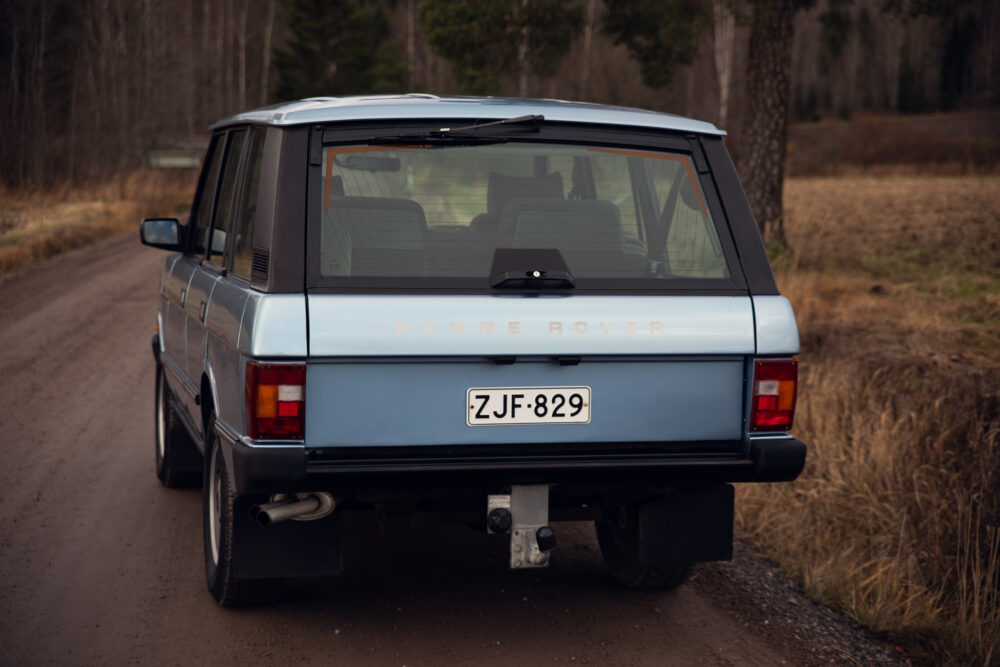 Vintage blue Range Rover on a dirt road
