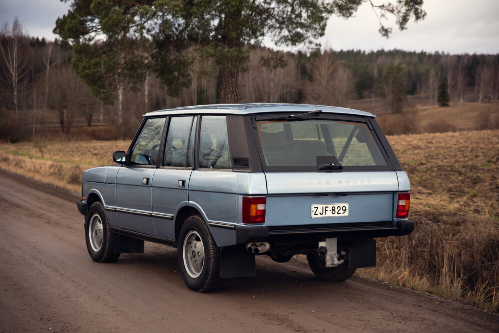 Vintage blue Range Rover parked on rural road