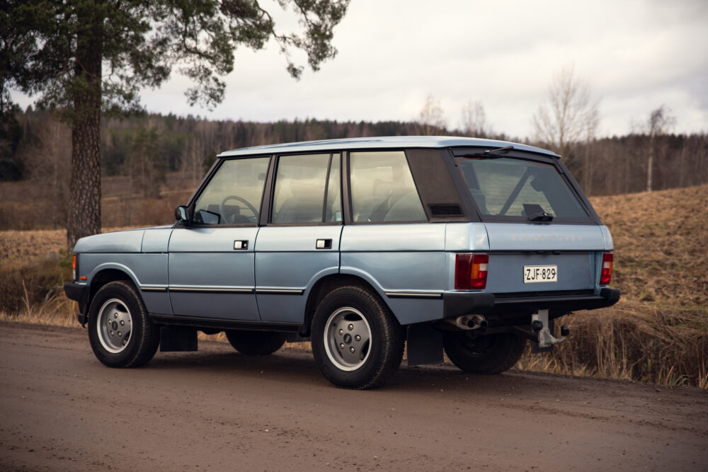 Vintage blue Range Rover parked on rural road