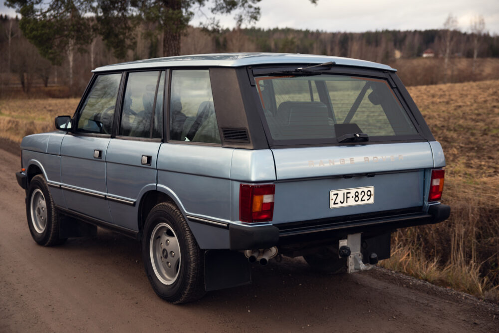 Vintage blue Range Rover parked on dirt road
