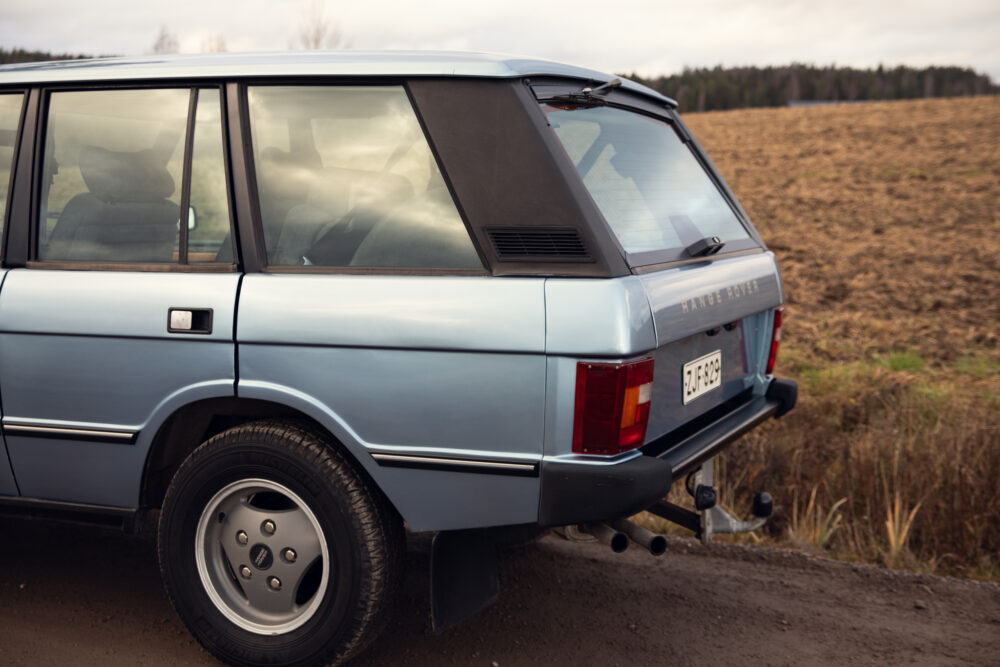 Vintage blue Range Rover parked in rural area