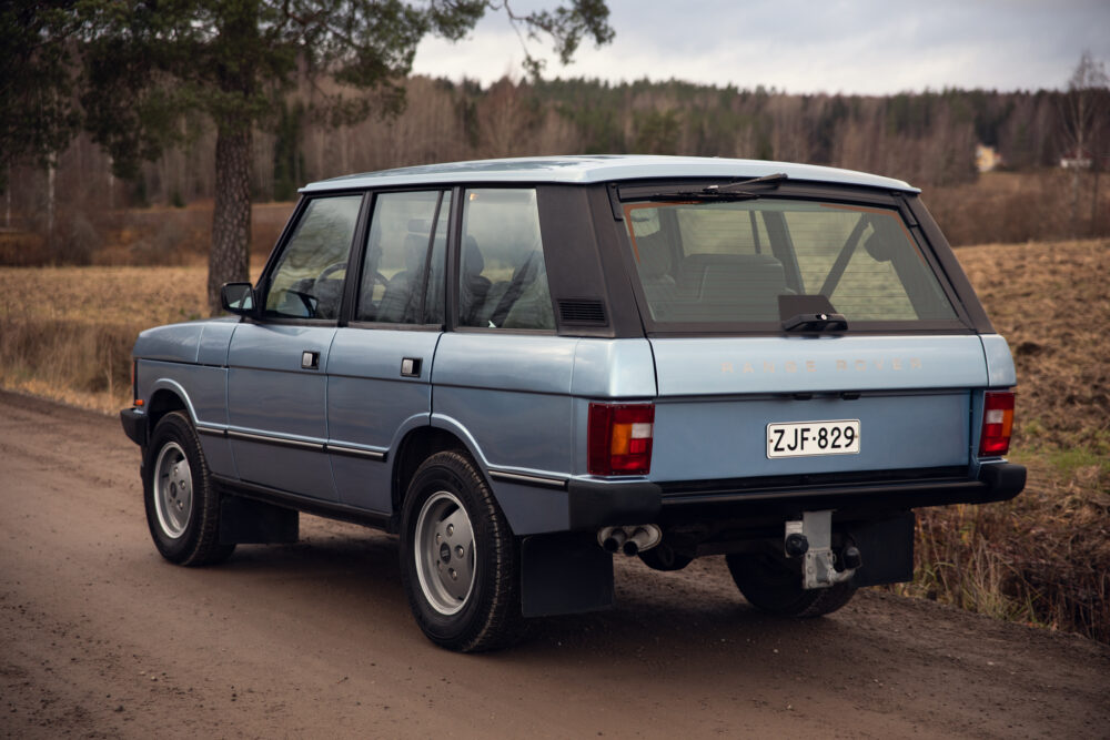 Vintage blue Range Rover parked on country road
