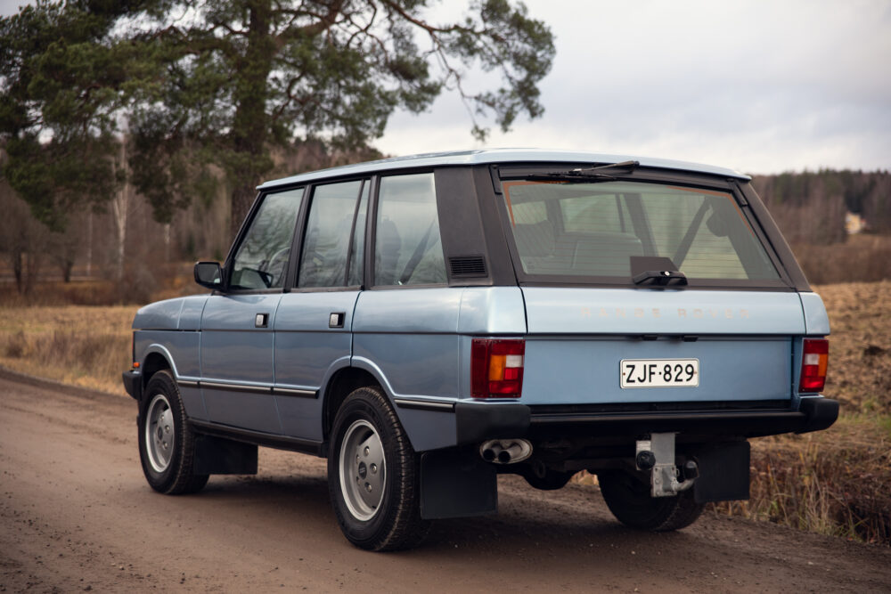 Vintage blue Range Rover parked on country road