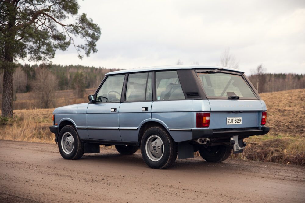 Vintage blue Range Rover parked on rural road