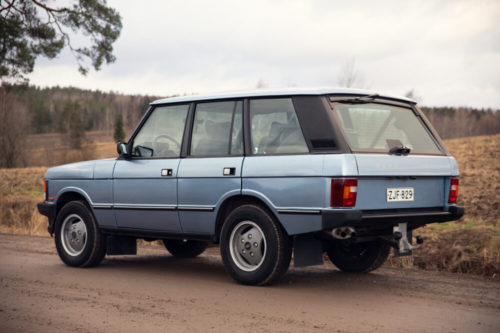 Vintage blue Range Rover parked on rural road