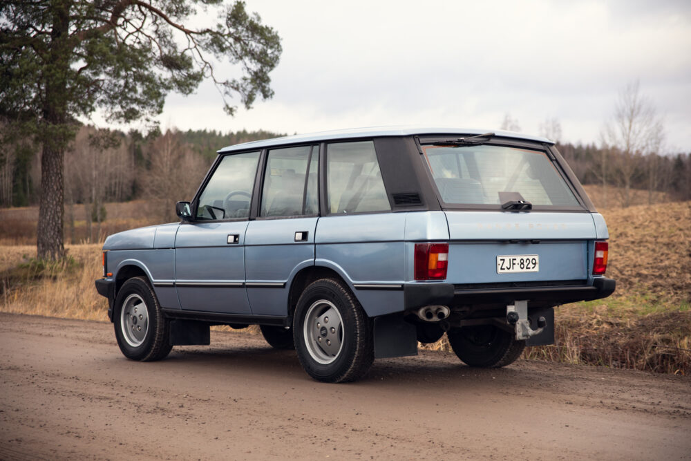 Vintage blue Range Rover on rural road