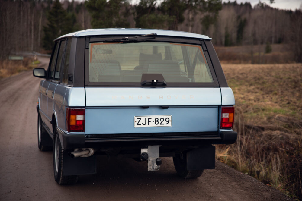 Vintage blue Range Rover on a rural road