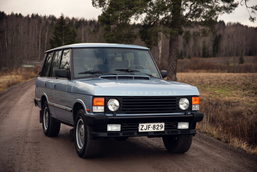 Vintage Range Rover parked on a rural road