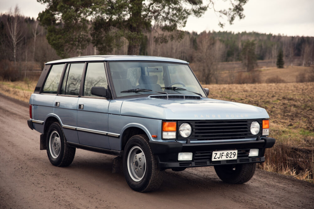 Vintage Range Rover parked on country road