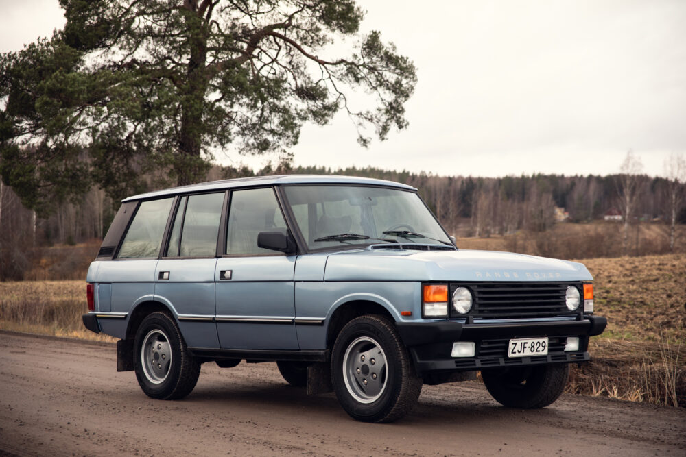Vintage blue Range Rover parked on rural road