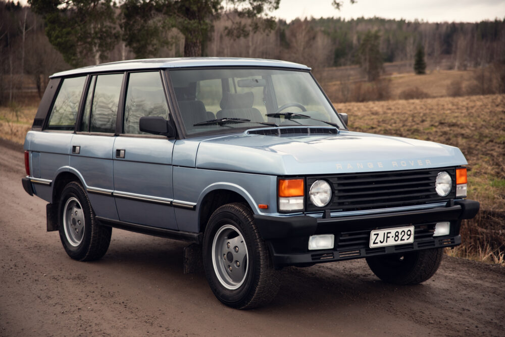 Vintage blue Range Rover on rural road