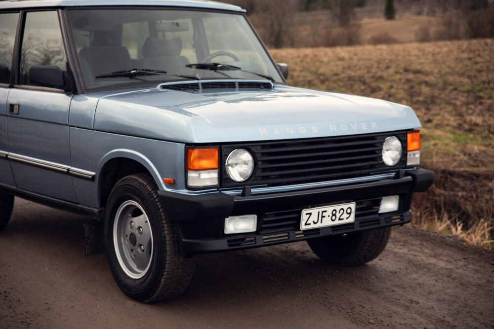 Vintage blue Range Rover on country road