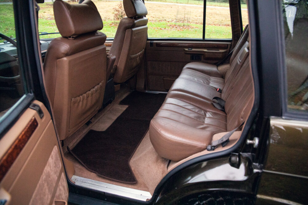 Open door of a car showing luxurious brown interior