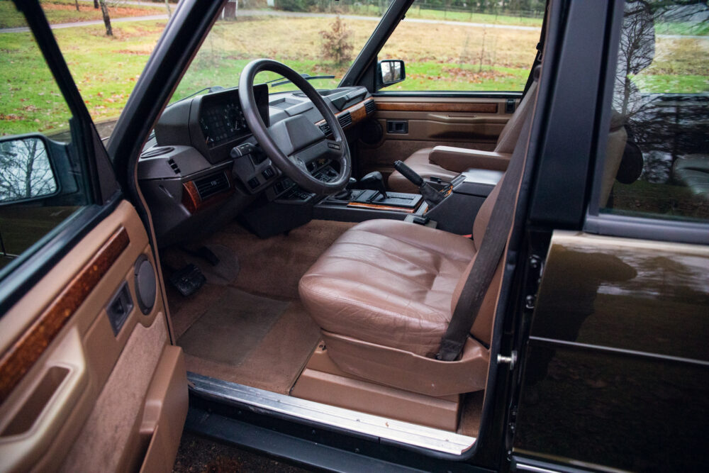 Vintage car interior with open driver's door