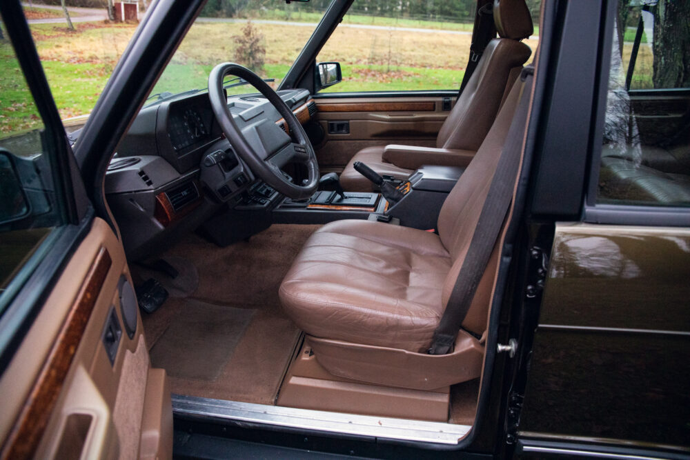 Vintage car interior with brown leather seats and dashboard