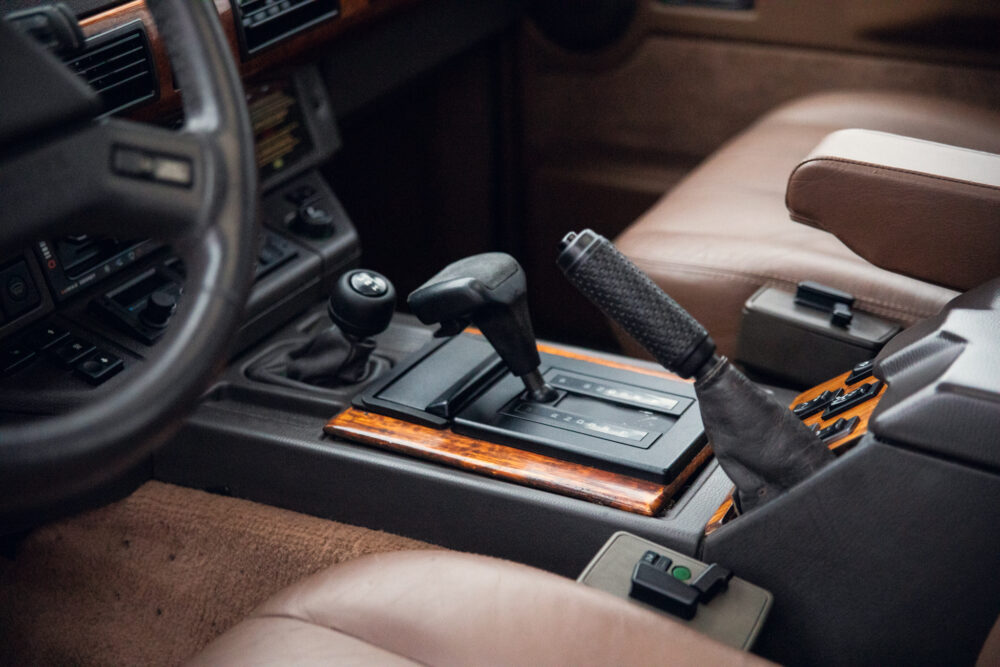 Vintage car interior with manual transmission and wooden trim