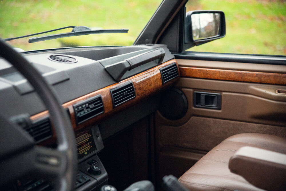 Vintage car interior with wood dashboard and leather seats