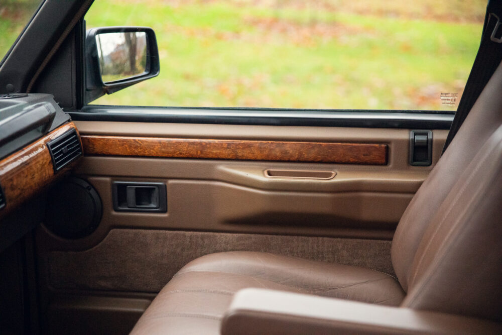 Vintage car interior with wooden panel and leather seats