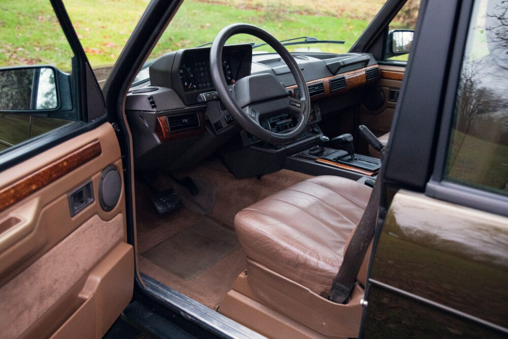 Vintage car interior with beige leather seats and dashboard
