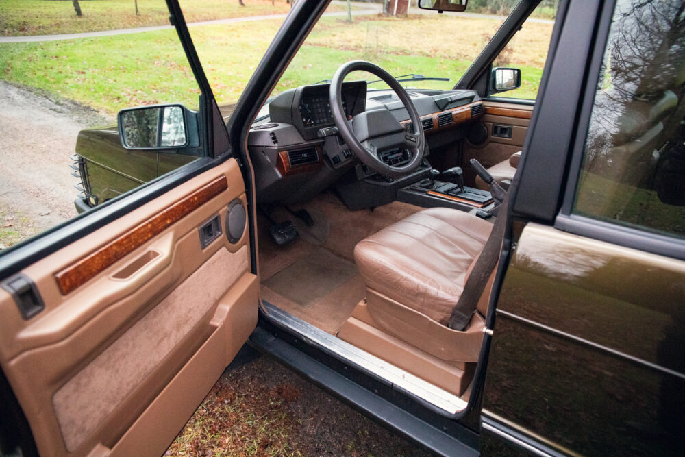 Vintage car's open door showing interior and dashboard