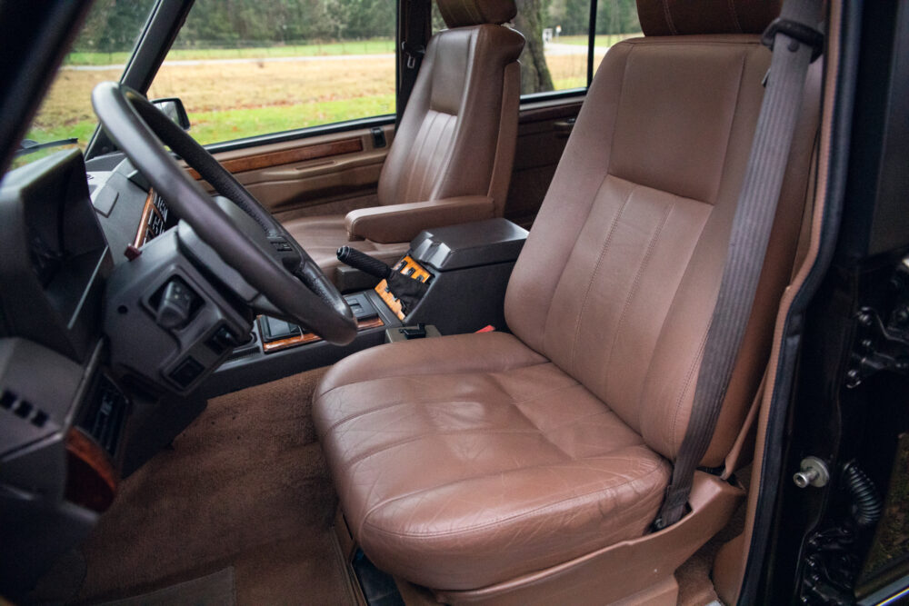 Vintage car interior with brown leather seats and dashboard