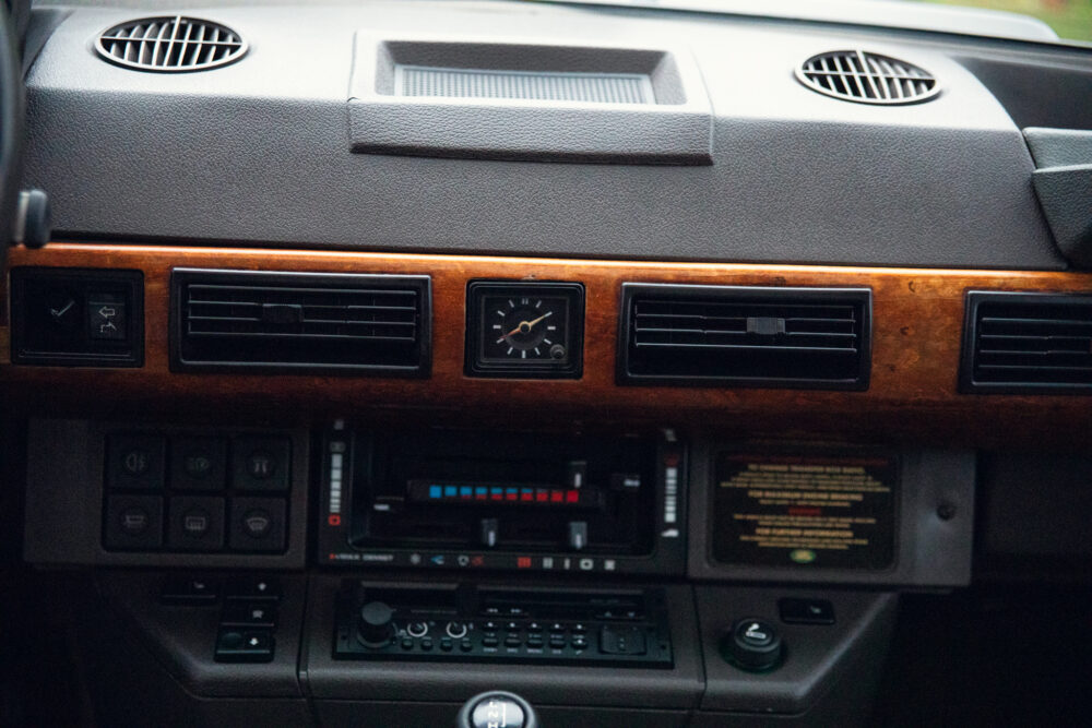 Vintage car dashboard with wooden panel and controls