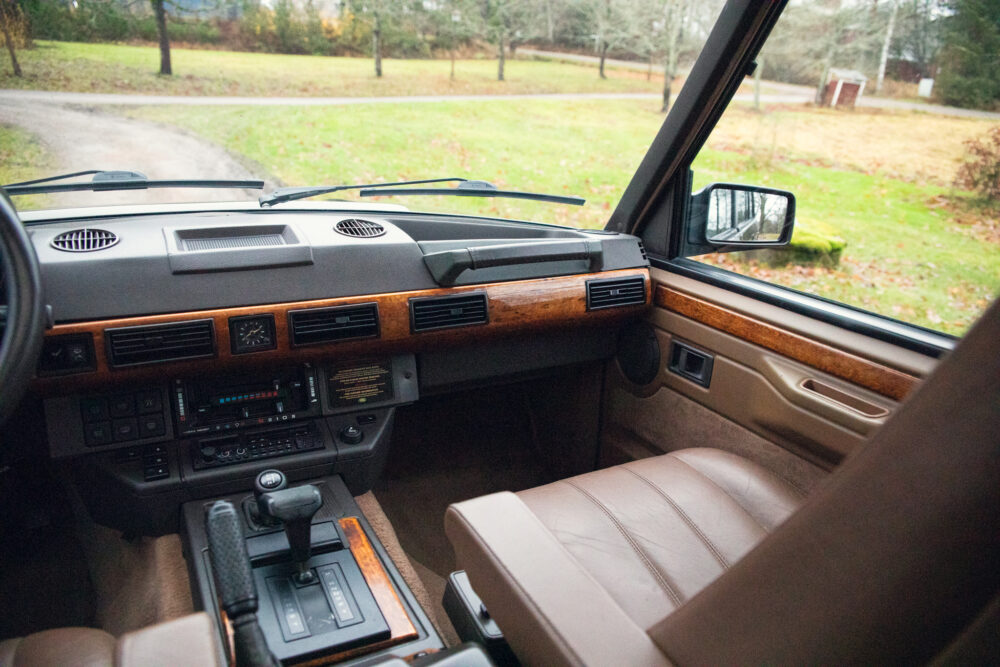 Vintage car interior with wooden dashboard and leather seats