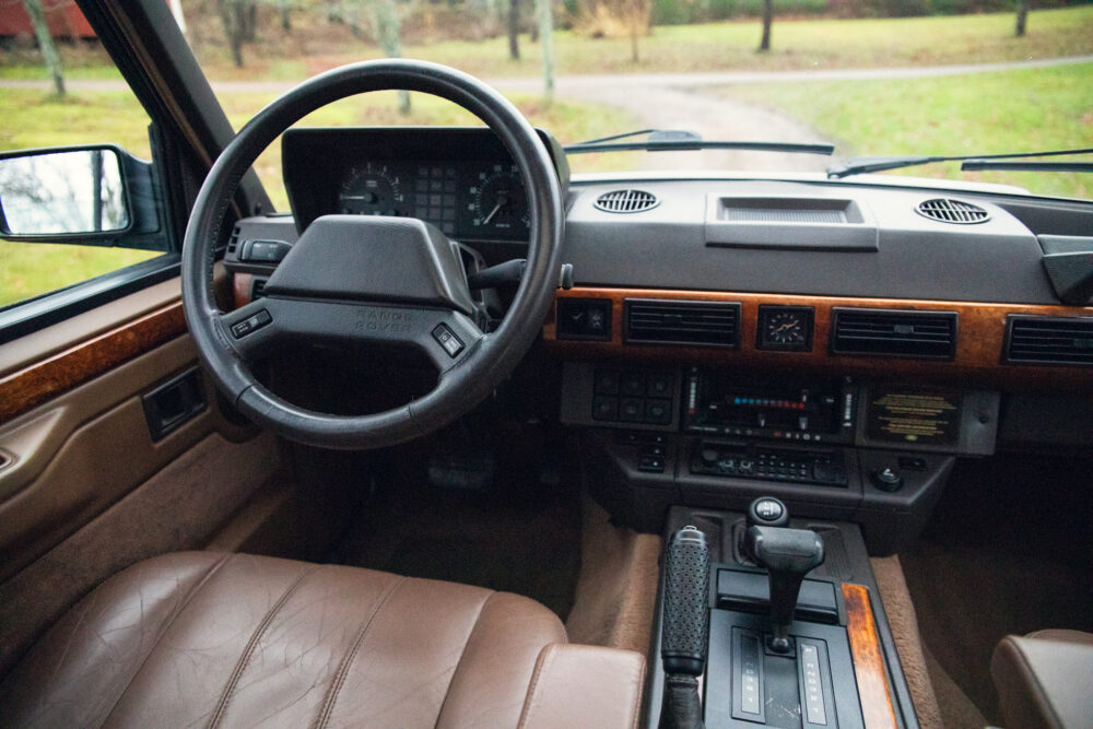 Vintage car interior with leather seats and wooden dashboard