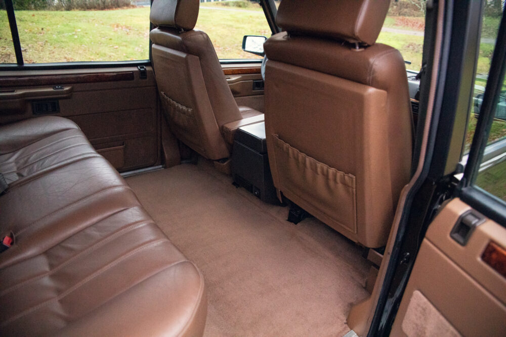 Interior view of vehicle showing tan leather seats