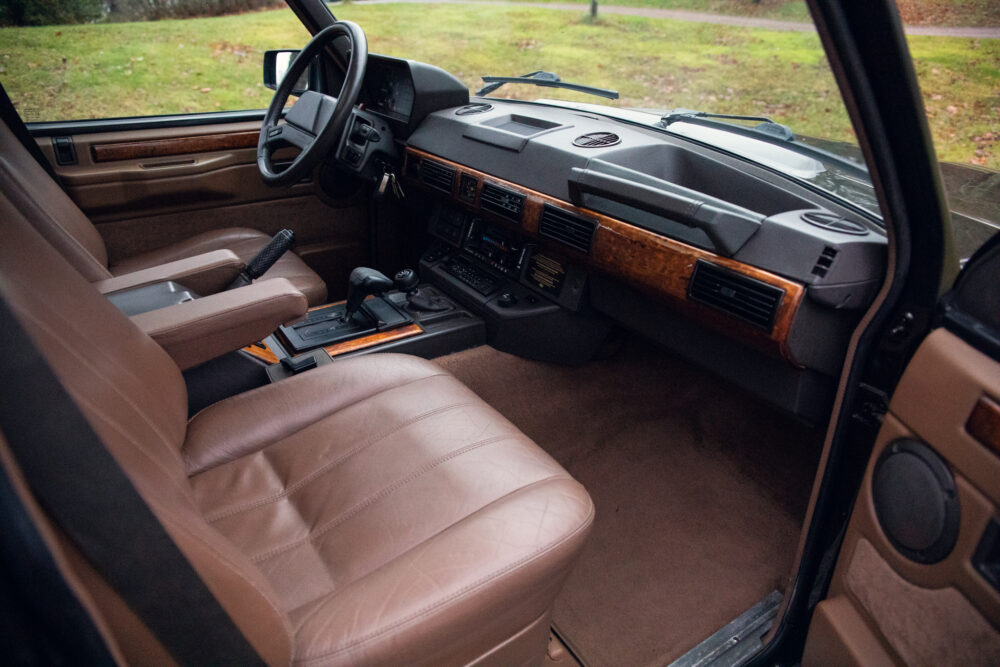 Vintage car interior with brown leather seats and dashboard