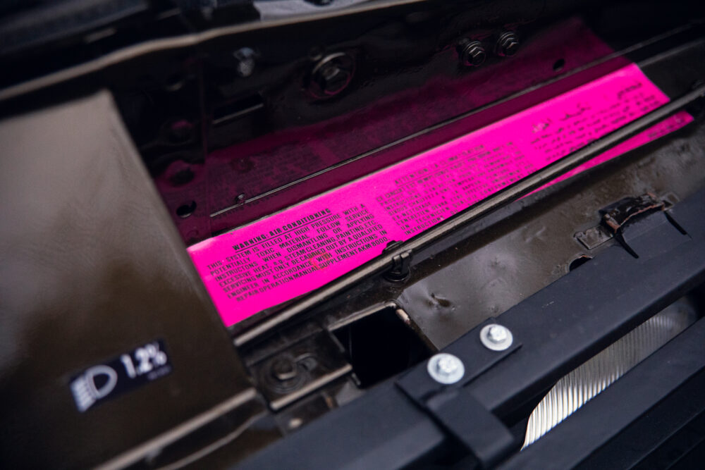 Close-up of machinery with detailed warning label