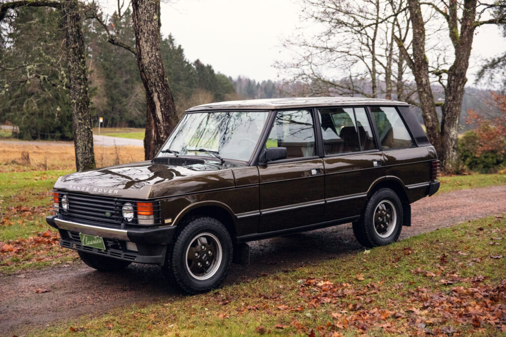 Vintage Range Rover parked outdoors near trees